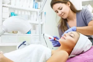 Esteticista realizando tratamento de pele em cliente